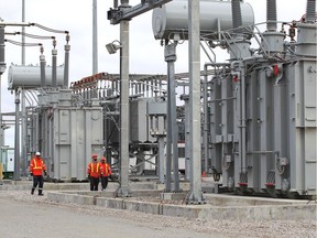 Crews walk through the massive Leamington Transmission Station built by Hydro One and Independent Electricity System Operator on Road 6 in Leamington Thursday.  The project aims to support the growth of the greenhouse industry along with other sectors including housing.
