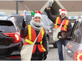 Wendy Desjardins and her husband Jim Desjardins volunteer by selling Goodfellows papers at Tim Hortons on Tecumseh Road East Thursday morning.