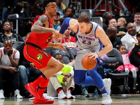 Blake Griffin of the Detroit Pistons drives against John Collins of the Atlanta Hawks at Philips Arena on February 11, 2018 in Atlanta, Georgia.