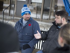 Rev. Ron Dunn, executive director of the Downtown Mission and Greg Lemay, left, sit on a bench outside the Mission's Wellness Centre on Ouellette Avenue where they'll stay for 24 hours discussing homelessness and poverty, Thursday, Nov. 14, 2019.