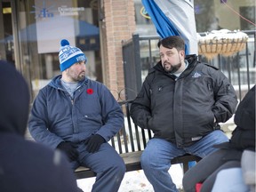 Rev. Ron Dunn, executive director of the Downtown Mission and Greg Lemay, left, sit on a bench outside the Mission's Wellness Centre on Ouellette Avenue where they'll stay for 24 hours discussing homelessness and poverty, Thursday, Nov. 14, 2019.