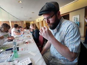 Michael Baumtrog, 33, swabs his mouth during a bone marrow clinic clinic at the University of Windsor's CAW Centre.
