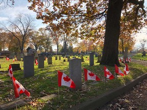 Canadian flags decorate the graves of veterans at Windsor Grove Cemetery in November 2019.
