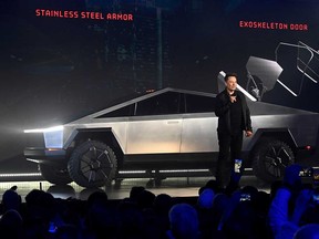 Tesla CEO Elon Musk shows off his company's all-electric Cybertruck at the TeslaDesign Studio in Hawthorne, California, on Nov. 21, 2019.