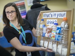 WINDSOR, ONT:. NOVEMBER 14, 2019 -- Lauri McQueen, a registered dietician and certified diabetes educator with the Windsor Essex Community Health Centre, holds up an education display showing the amount of sugar in popular beverages during an open house marking World Diabetes Day, Thursday, Nov. 14, 2019.