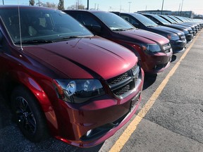 A line of Dodge Grand Caravans, rated among the most reliable vehicles in the latest Consumer Reports survey, are shown at the Motor City Chrysler dealership in this Nov. 28, 2017, file photo.