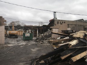 An excavator sits inside the former El Mayor restaurant as crews prepare to demolition the burnt out building, Wednesday, Nov. 27, 2019.