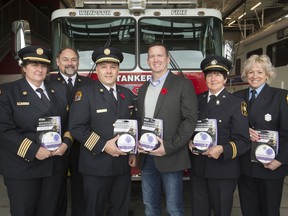 Windsor Fire and Rescue Chief, Stephen Laforet, centre-left, and Brian Chauvin, operations manager at Enbridge Gas Inc., are joined on the left by deputy chief, Andrea De Jong, and chief fire prevention officer, John Lee, and Nelly Green, fire protection advisor, and Nancy Christ, public education officer, during a press event announcing the donation of 360 smoke and CO detectors on Monday, Nov. 4, 2019.