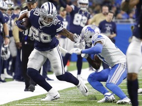 Dallas Cowboys running back Tony Pollard stiff arms Detroit Lions cornerback Justin Coleman during the fourth quarter at Ford Field.