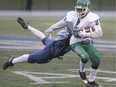 Tai Colquhoun, of the Herman Gren Griffins, shakes off a tackle from Logan Stefina, of the Chatham Ursuline Lancers, during Thursday's SWOSSAA football AAA final at Alumni Field.