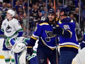 St. Louis Blues centre Robby Fabbri is congratulated by center Tyler Bozak after scoring against Vancouver Canucks goaltender Thatcher Demko during the first period at Enterprise Center.