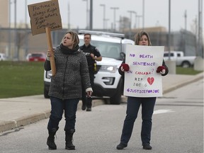 A couple of participants in a rally are shown in front of the South West Detention Centre in Windsor on Nov. 10, 2019. Family and friends of Joe Gratton who died in the jail were part of the group.