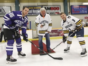 As part of the University of Windsor Lancers Against Bullying campaign, Mike Neuts of Chatham drops the ceremonial face-off puck at a men's hockey match between the Lancers and University of Western Ontario on Nov. 22, 2019, at Windsor's Capri Pizzeria Recreation Complex. Mike's son Myles, who had been tormented by bullies, was found hanging from a coat hook in a school bathroom in Chatham in 1998. About 260 local Grade 7 and 8 students were invited to hear Neuts speak on bullying Friday before getting to enjoy the game. Here, Western's Ryan Bechtel, left, and Windsor's Ben Assad, respective team captains, take the face-off.