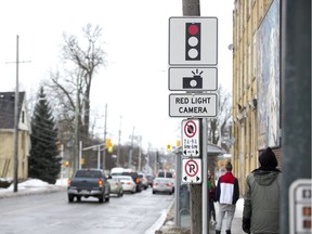 A sign alerts drivers to the presence of a red light camera at the intersection of Adelaide Street and Queens Avenue in London, Ont. on Thursday February 14, 2019.
