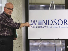 Chris Woodrow, director of corporate services with the Windsor Public Library displays the organization's new logo during a board meeting on Tuesday, November 19, 2019.