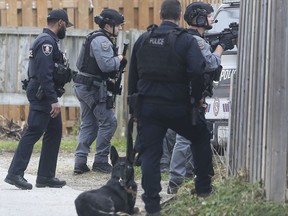 Heavily armed Windsor Police officers are shown at a house in the 1500 block of Marentette Ave. for a possible weapon possession call on Tuesday, November 26, 2019.