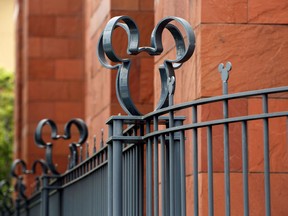 The Walt Disney Co. Mickey Mouse logo is seen on a fence at the company's studios in Burbank, California.