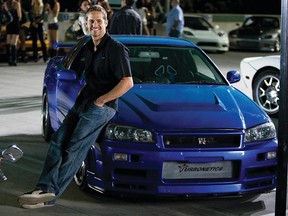 Paul Walker as agent Brian O'Conner leans against his 1998 Nissan Skyline GTR in the ultimate chapter of the franchise built on speed.