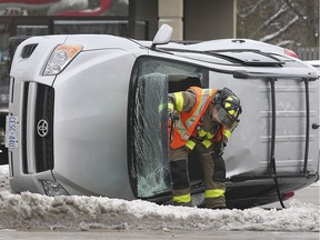 A Windsor firefighter and policeman are shown at the scene of a rollover accident on Wednesday, November 13, 2019, at the intersection of Lauzon Pkwy and Tecumseh Road East The accident occurred at 12:30 p.m. and shut down eastbound lanes of Tecumseh for approximately an hour. Injuries were not life-threatening.