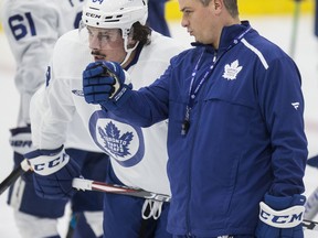 Maple Leafs head coach Sheldon Keefe talks with young star Auston Matthews during practice at the Ford Performance Centre on Monday. (Craig Robertson/Toronto Sun)