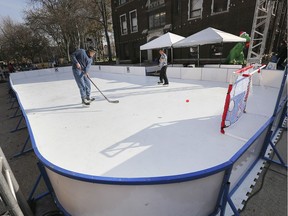 University of Windsor students Spencer Ogston and Catherine Muldoon play hockey on a synthetic ice surface in the student courtyard on Tuesday, November 26, 2019. The fun was part of the Skate the Date event which is a three day winter festival.