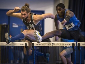 The Windsor Lancers' Nathan Hesman, left, competes against Leewinchell Jean in the men's 60-metre hurdles at the 38th Blue and Gold track meet at the Dennis Fairly Fieldhouse on Monday.