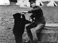Archive photo shows Lt. Harry Colebourn, a veterinarian, feeding the bear cub he adopted near White River, Ont., and named Winnie in honour of his hometown of Winnipeg.