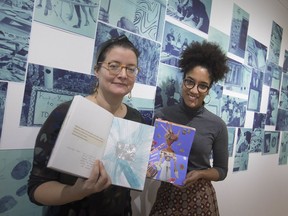 Julie Tucker, left, Arts Council director, and Talysha Bujold-Abu, gallery manager and membership co-ordinator, display some journals from the 100 Journals exhibit on the opening night of the exhibit at Artspeak Gallery, Wednesday, Dec. 11, 2019.