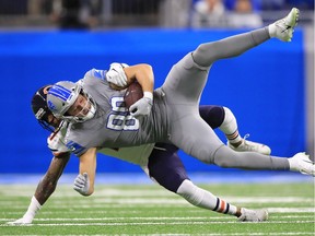 T.J. Hockenson of the Detroit Lions battles for yards after a first half catch against Ha Ha Clinton-Dix of the Chicago Bears at Ford Field on November 28, 2019 in Detroit, Michigan.