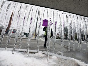 A brutally cold February ranks No. 4 on this year's Top 10 Environment Canada weather stories. Shown here on Feb. 12, 2019, security guard Jan Ryersee assists motorists on Alsace Avenue in Windsor as freezing rain fell, producing icicles by the thousands.