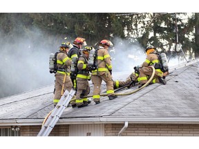 Windsor, Ontario Dec. 6, 2019. Windsor firefighters battle a roof and attic fire at 2505 McKay Avenue in South Windsor Friday afternoon.  Firefighters had to cut a hole in the roof to access the blaze and they remained on the scene for over a hour.  There were no injuries.