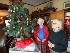 Kingsville, Ontario Dec. 8, 2019. Author Jane Buttery, left, and Jill Nicholson, Acting Education and Public Programs Co-ordinator, admire century old Christmas tree ornaments during Sunday's Jack Miner Migratory Bird Sanctuary Country Christmas event.  Dozens of area residents and visitors toured the original home and buildings and about 20 took a hike along Jack Miner Trail System.