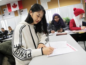 Cen Shen, a student at St. Michael's Adult Secondary School in Windsor, writes a holiday letter to active members of the Canadian Armed Forces as part of a letter writing campaign involving three local high schools on Tuesday, Dec. 10, 2019.