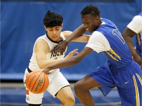 St. Joseph's Lasers Gabriel Rosete, left, loses the ball against Kennedy Clippers Mazin Tiea in a semifinal game of the 63rd Annual University of Windsor Invitational at the Dennis Fairall Fieldhouse on Saturday.