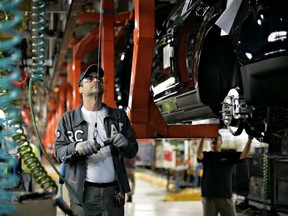 A Ford employee works on the line at an assembly facility on June 3, 2008 in Oakville, Ont.