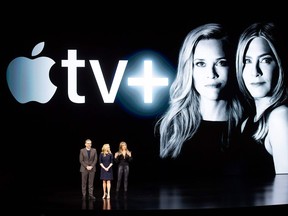 (FILES) In this file photo taken on March 25, 2019 Actors Steve Carell, Reese Witherspoon and Jennifer Aniston speak during an event launching Apple tv+ at Apple headquarters, in Cupertino, California. - The streaming television war is set to enter a new phase as titans Apple and Disney take direct aim at market leader  Netflix, vying for consumers abandoning their cable TV bundles for on-demand services.