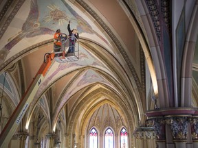Eric Stewart with Historic Plaster Conservation Services, inspects the ceiling of Assumption Church on March 7,  2019.