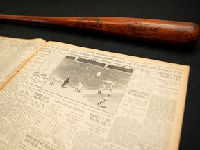 Babe Ruth's 500th home run bat is shown next to a copy of the next day's New York Times before it went up for auction by SCP Auctions in Laguna Niguel, Calif., Nov. 25, 2019.