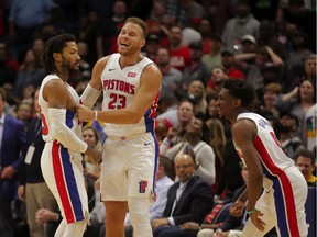 Detroit Pistons guard Derrick Rose celebrates with teammates forward Blake Griffin and guard Langston Galloway after hitting a game winning shot during the fourth quarter against the New Orleans Pelicans at the Smoothie King Center.