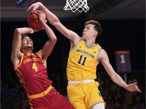 Michigan Wolverines forward Colin Castleton blocks the shot of Iowa State Cyclones forward George Conditt IV during the first half at Imperial Arena.