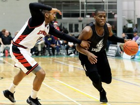 London Lightning's Abednego Lufile, right, drives to the basket against Windsor Express's Deilvez Yearby in the second half of a National Basketball League of Canada exhibition game at St. Clair College's Chatham Campus HealthPlex in Chatham, Ont., on Saturday, Dec. 14, 2019. Mark Malone/Chatham Daily News/Postmedia Network