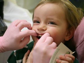 In this file photo, a toddler is shown being examined by a dental hygienist at a Developmental Health and Wellness Fair hosted by the Windsor-Essex County Health Unit.