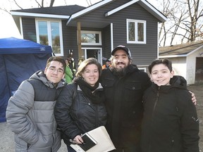 The Fortuna family, from left, Logan, 14, Nicole, Serafim and Dean 14, pose in front of their new home on Maple Avenue in Kingsville on Monday, as Habitat for Humanity Windsor-Essex held a dedication ceremony for their 66th and 67th homes.