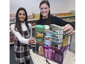 The Unemployed Help Centre's Johanna Coutinho, left, and Heidi Benson, show examples of healthy food donations on Monday, December 16, 2019.