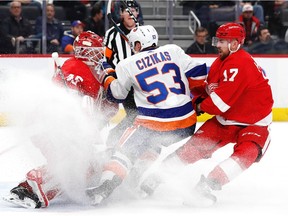 New York Islanders center Casey Cizikas (53) stop short of Detroit Red Wings goaltender Jonathan Bernier (45) chased by defenseman Filip Hronek (17) in the first period at Little Caesars Arena.