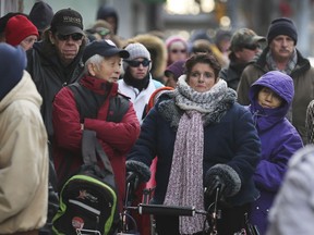 People wait in line for the 15th annual Mikhail Holdings Holiday Turkey Giveaway in downtown Windsor on Friday.