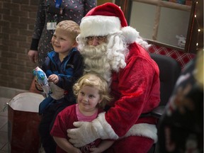 Ho! Ho! Ho! Donnavan Figuary-Healey, 4, left, and Kimberley Macaree, 3, enjoy some quality time with Santa Claus at the Downtown Mission on Wednesday, Dec. 18, 2019, as the shelter served up Christmas dinner with all the fixings for about 260 guests. Santa brought gifts for the kids.