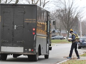 A UPS driver delivers a package in east Windsor on Dec. 16, 2019.