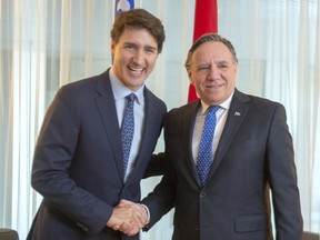 Prime Minister Justin Trudeau shakes hands with Quebec Premier Francois Legault before their meeting in Montreal on Dec. 13, 2019.