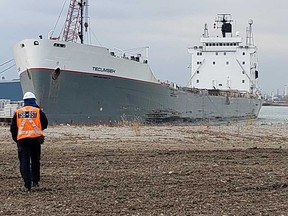 An investigator with the Transportation Safety Board of Canada approaches the bulk carrier the Tecumseh at the Detroit River on Dec. 17, 2019.